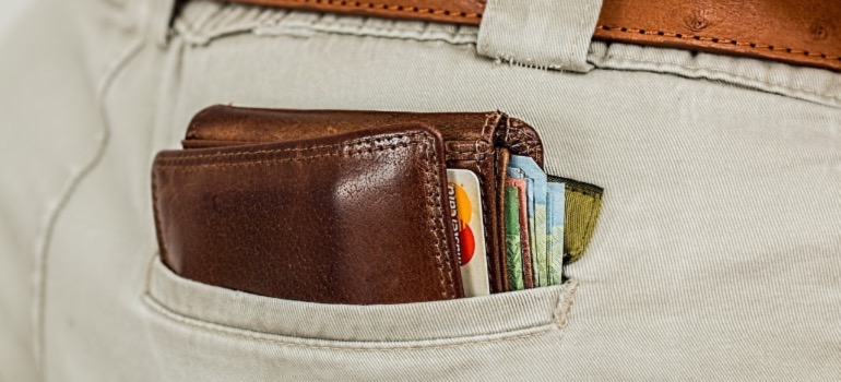 A wallet sticking out of a person's back pocket