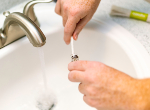 A person doing maintenance according to essential plumbing tips for new homeowners