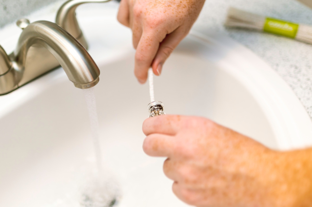 A person doing maintenance according to essential plumbing tips for new homeowners